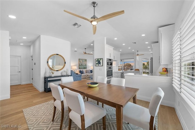 dining room featuring ceiling fan and light hardwood / wood-style flooring