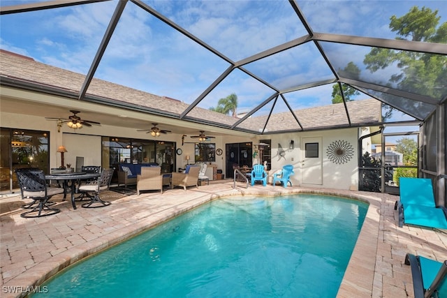 view of swimming pool featuring ceiling fan, a lanai, and a patio area