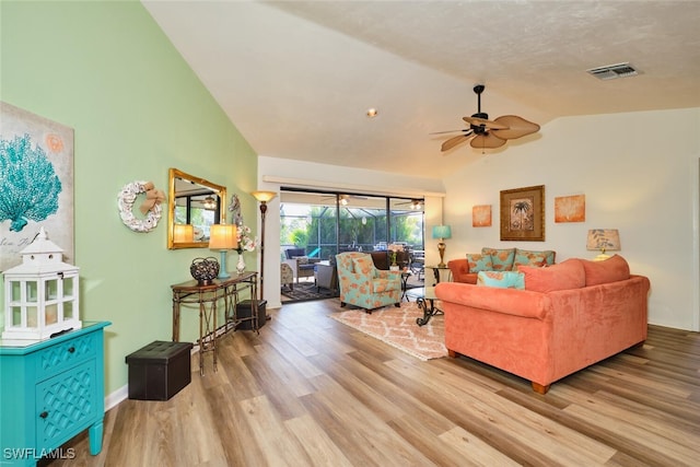 living room with vaulted ceiling, light hardwood / wood-style floors, and ceiling fan