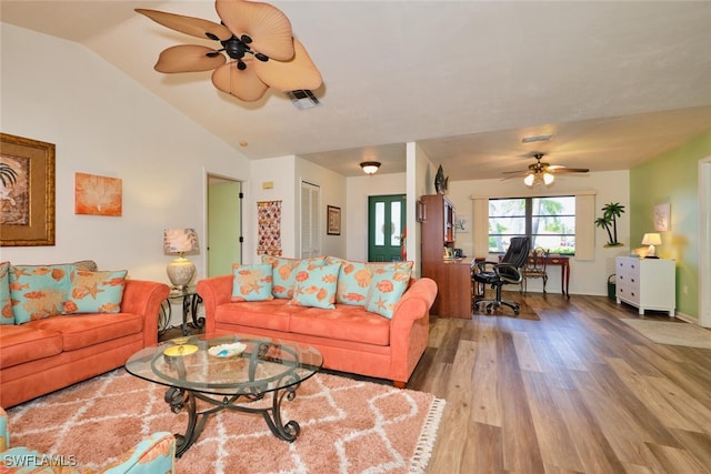 living room featuring ceiling fan, lofted ceiling, and light wood-type flooring