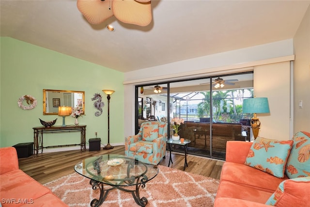 living room featuring ceiling fan, lofted ceiling, and hardwood / wood-style floors