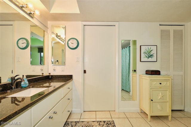 bathroom with tile patterned flooring and vanity