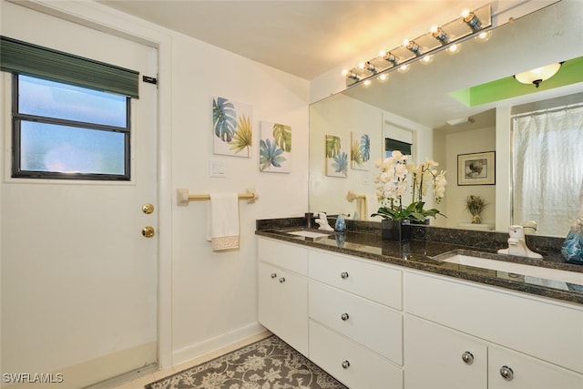 bathroom featuring tile patterned flooring and vanity