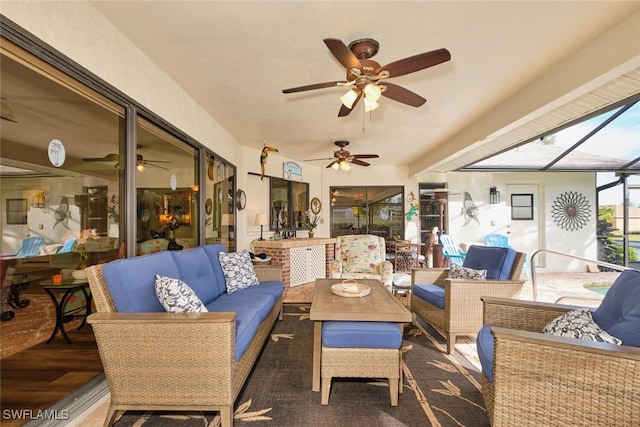 exterior space featuring ceiling fan, outdoor lounge area, and glass enclosure