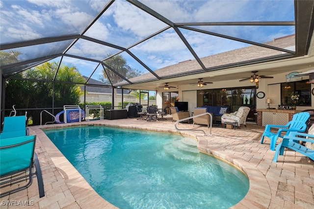 view of pool featuring an outdoor living space, a lanai, a patio area, and ceiling fan