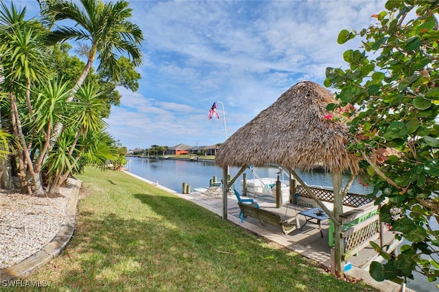 dock area with a yard, a patio area, and a water view