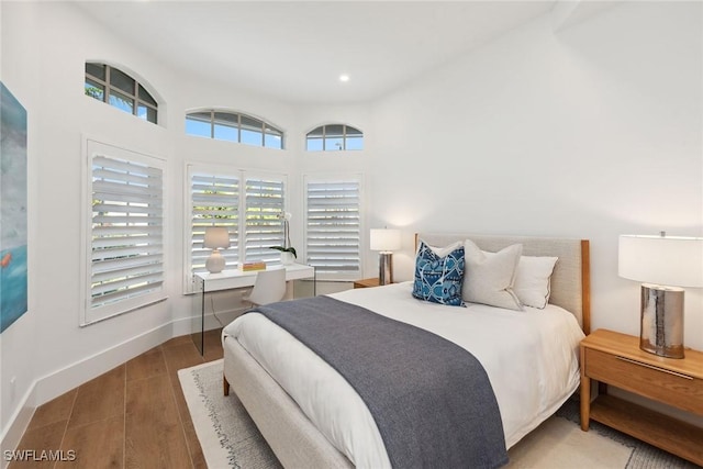 bedroom with recessed lighting, baseboards, and wood finished floors