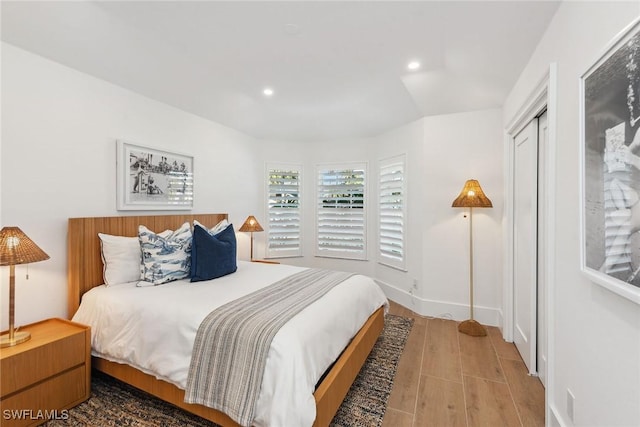 bedroom featuring baseboards, recessed lighting, and light wood-style floors