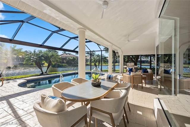 sunroom / solarium with a water view, ceiling fan, and lofted ceiling