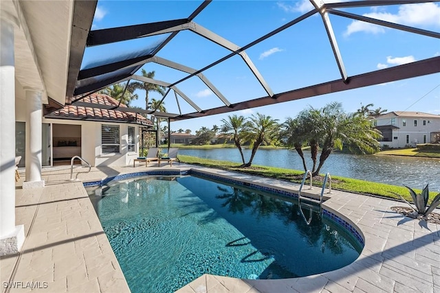 pool featuring a patio area, glass enclosure, and a water view