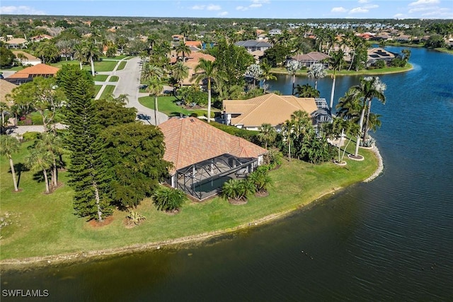 drone / aerial view with a water view and a residential view