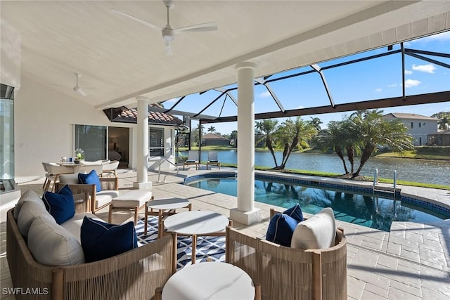 outdoor pool with a water view and ceiling fan