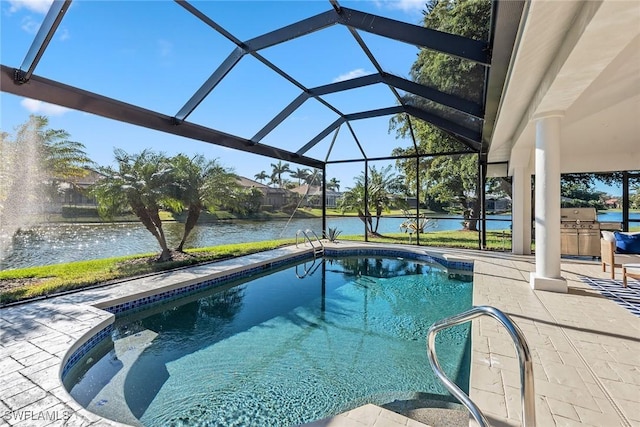 pool featuring a patio, an outdoor kitchen, a lanai, a water view, and a grill