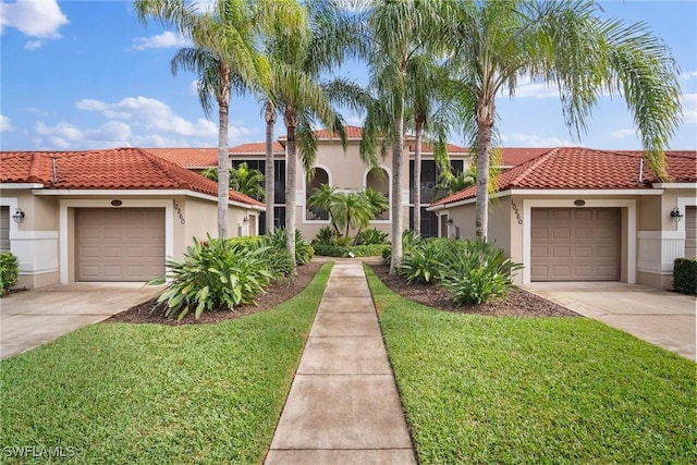 mediterranean / spanish-style house featuring a garage and a front yard