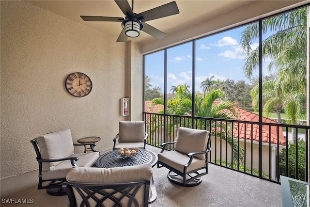 sunroom / solarium featuring ceiling fan