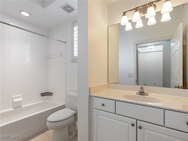 full bathroom with vanity, tile patterned flooring, tiled shower / bath, and toilet