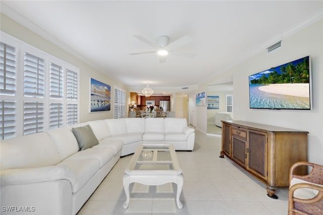 living room with ornamental molding, light tile patterned floors, and ceiling fan