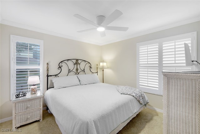 bedroom featuring ornamental molding, light colored carpet, and ceiling fan