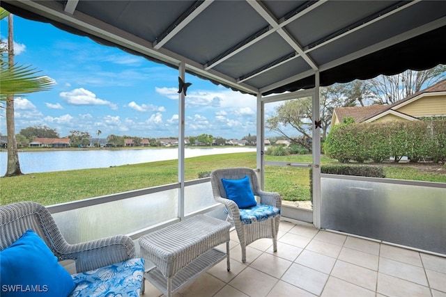 sunroom featuring a healthy amount of sunlight and a water view