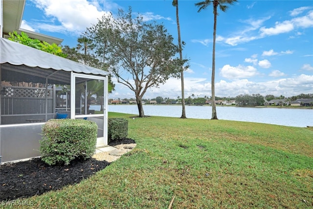 view of yard with a water view and a sunroom