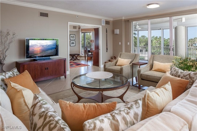 living room with crown molding, plenty of natural light, and light tile patterned floors