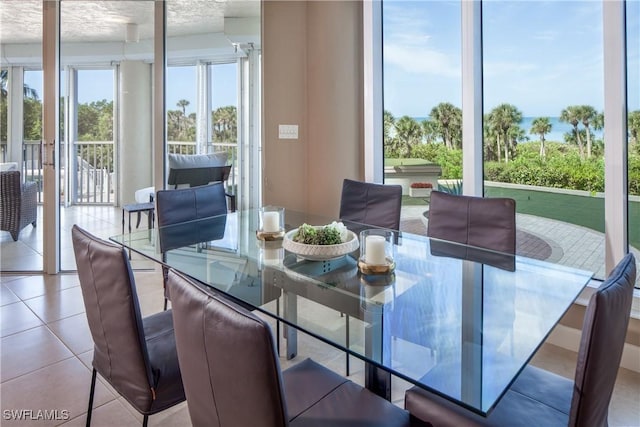 tiled dining area featuring a textured ceiling