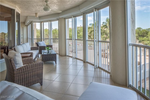 sunroom featuring ceiling fan