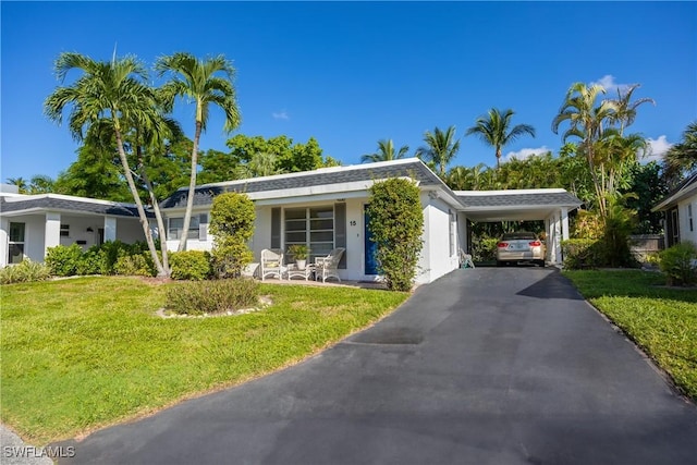 single story home featuring a carport and a front lawn