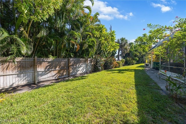 view of yard featuring glass enclosure