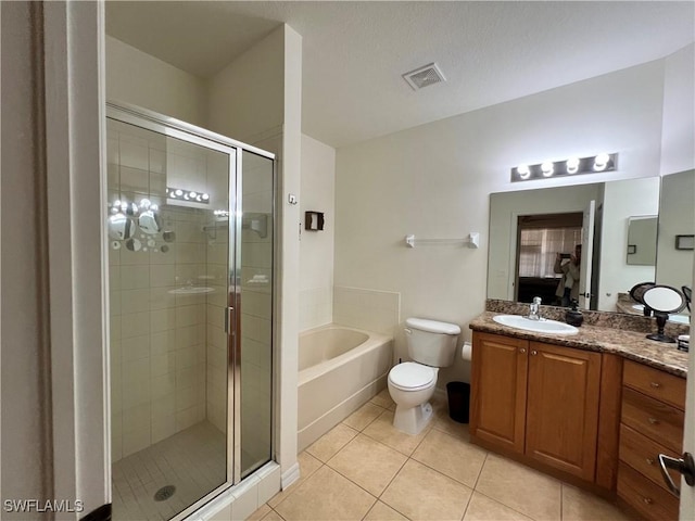 bathroom with vanity, tile patterned flooring, a shower stall, visible vents, and a garden tub