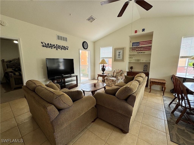 living room with visible vents, a ceiling fan, vaulted ceiling, and light tile patterned floors
