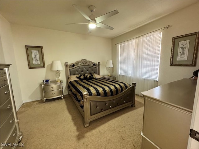 bedroom featuring light carpet and ceiling fan