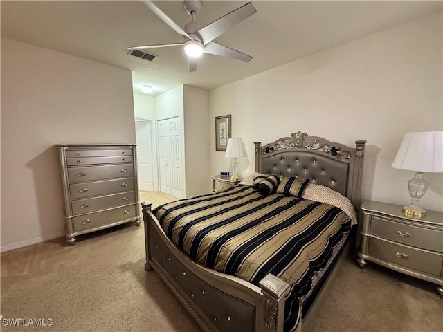 carpeted bedroom featuring visible vents, ceiling fan, a closet, and baseboards