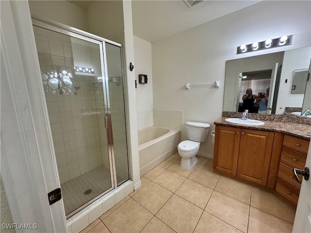 bathroom with tile patterned flooring, vanity, a bath, and a stall shower