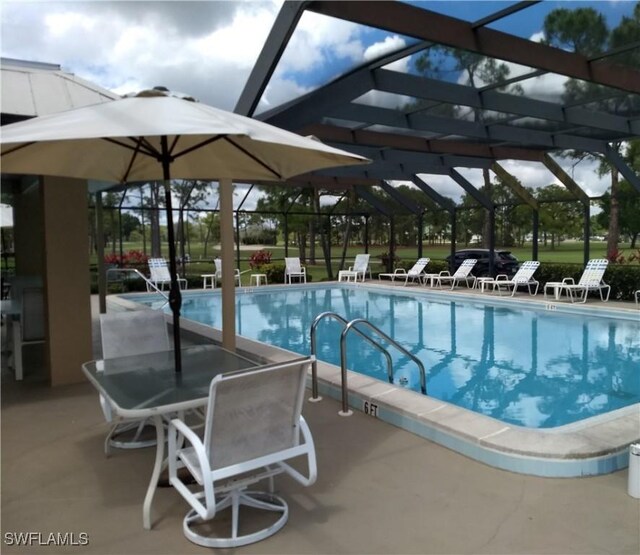 view of pool featuring a patio area and glass enclosure