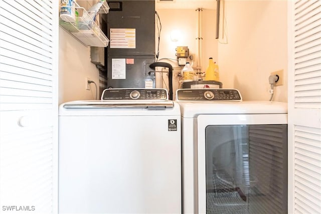 laundry area with independent washer and dryer, laundry area, and heating unit