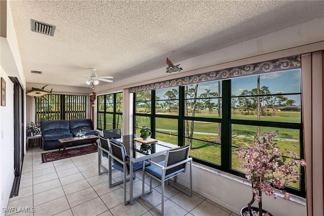 sunroom with outdoor lounge area, a textured ceiling, and visible vents