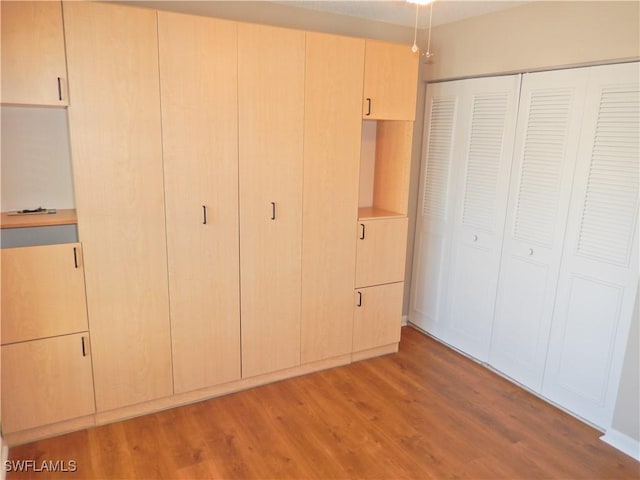 unfurnished bedroom with light wood-type flooring