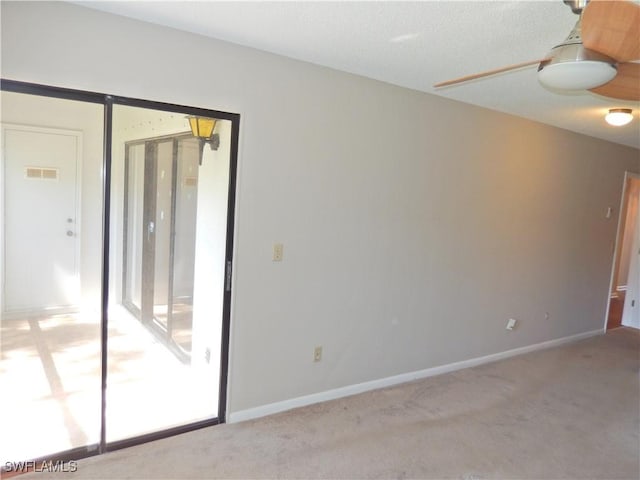 unfurnished room featuring light carpet