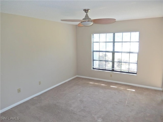 carpeted empty room featuring ceiling fan