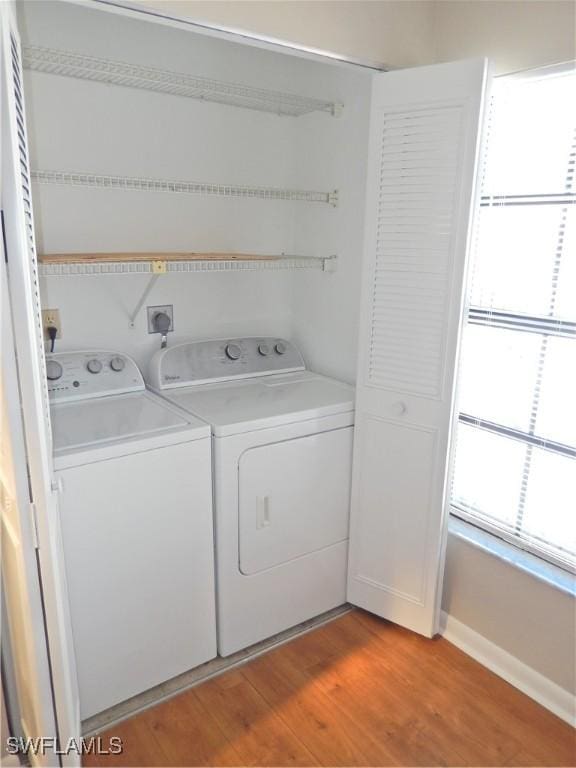 laundry area featuring independent washer and dryer and wood-type flooring