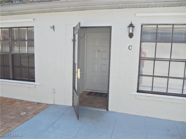 doorway to property with stucco siding