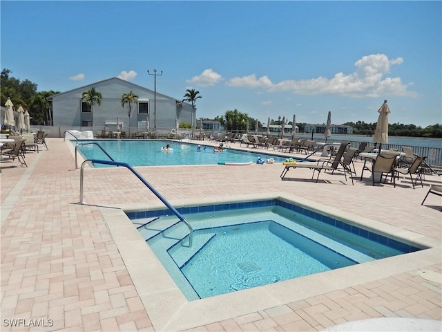 view of pool featuring a community hot tub and a patio