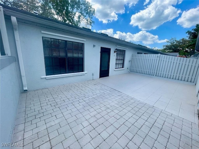 view of patio / terrace featuring fence