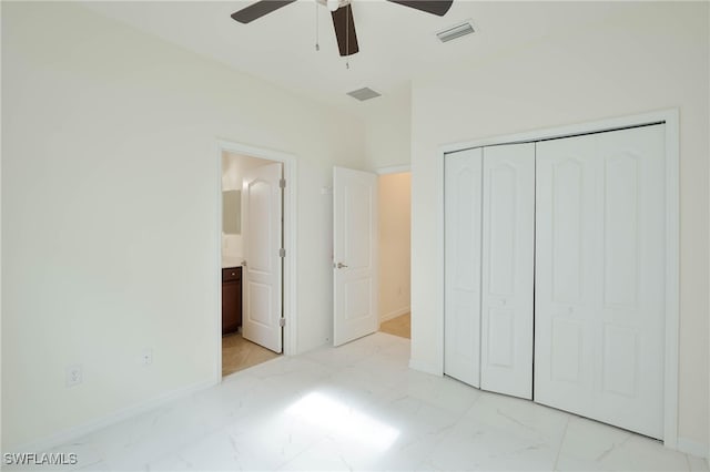 unfurnished bedroom with a closet, ceiling fan, and ensuite bathroom