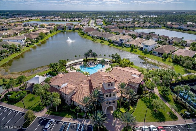 birds eye view of property with a water view