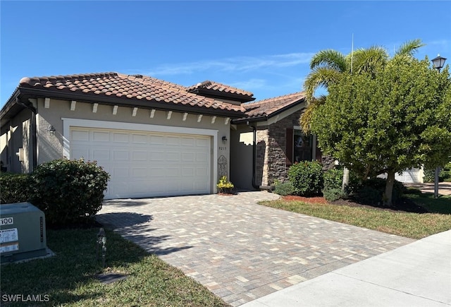 mediterranean / spanish-style house with a garage