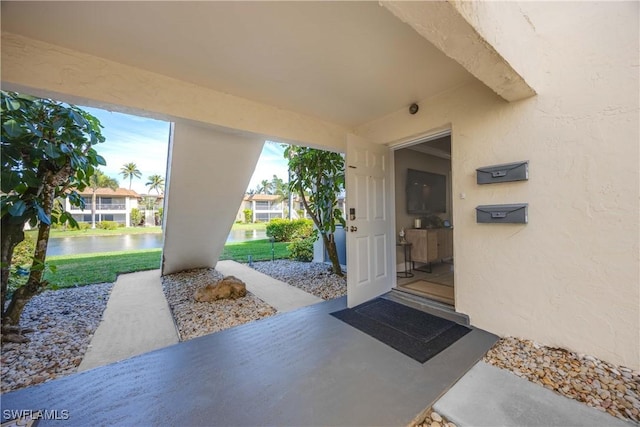 doorway to property with a water view