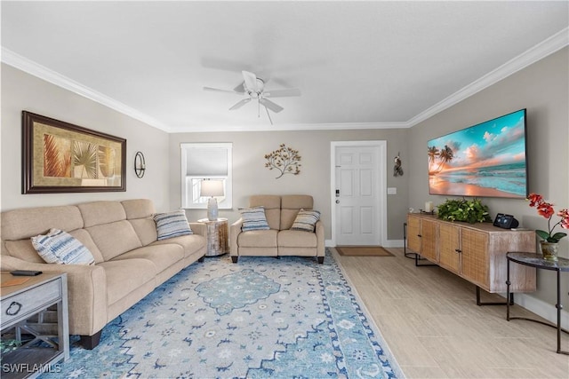 living room with light hardwood / wood-style flooring, ornamental molding, and ceiling fan