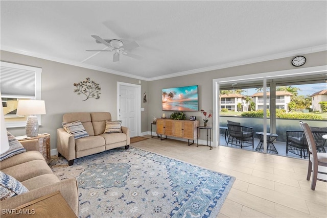 living room with ceiling fan and ornamental molding